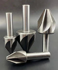 Close-up of four carbide chamfer end mills with silver shanks; includes 60° chamfer cutter