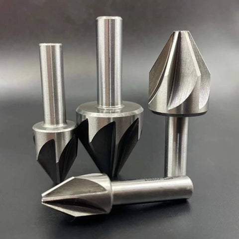 Close-up of four carbide chamfer end mills with silver shanks; includes 60° chamfer cutter