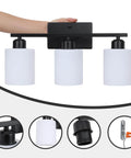 Three Light Black Matte Vanity Light Fixture With Milky White Frosted Glass Shades For Bathroom Over Mirror.