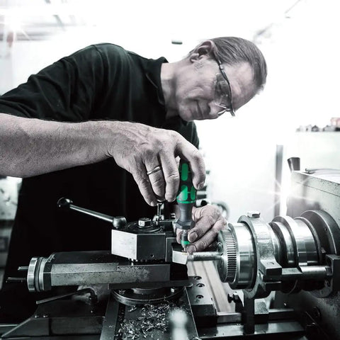 Person using Micro ESD Adjustable Torque Screwdriver 2.0 To 6.0 Ncm With Quick Release Chuck on machinery in a workshop.