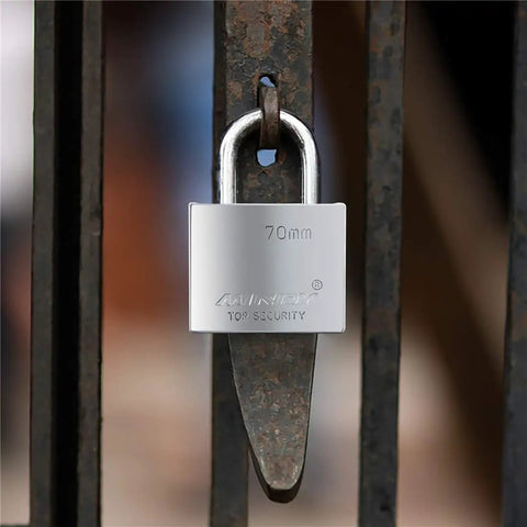 70mm Heavy Duty Beefy Padlock With Waterproof Seal For Indoor Outdoor Use, locked on a metal gate, made of alloy steel with brass cylinder