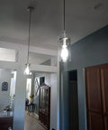 3 Pack Clear Glass Vintage Pendant Lights With Brushed Nickel Finish For Kitchen Island hanging in a home dining area