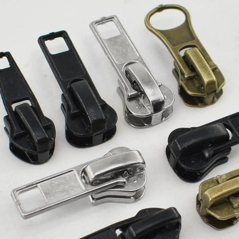 Close-up of 24Pcs Zipper Sliders Replacement Kit With Stops For Metal Plastic Nylon Coil Jackets Sizes 5 And 7