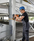 Heavy Duty Magnetic Base Drill Built Tough For One Quarter Inch Steel Cuts in use on metal structure with worker.