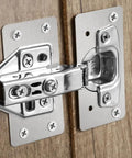 Close-up of All-In-One Stainless Steel Cabinet Hinge Repair Kit with side panel brackets and screws on wooden door cup base.