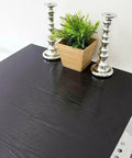 Gotta Have This Slick Black Peel And Stick Vinyl Wrap For Kitchen Countertops And Walls on a table with candles and a potted plant.