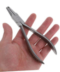 Hand holding Stainless Steel Eyeglass Repair Pliers With Nose Pad Tool 2 Piece Glasses Maintenance Kit For Quick Adjustments And Fixes Durable DIY Eyewear Repair Set For On The Go.