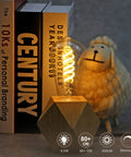 Vintage style LED filament bulb on wooden base next to books and a sheep figure, Six Pack G25 LED Globe Edison Bulbs Dimmable Filament Style E26 Base 6W Equal 60W Neutral White 4000K Glass Edison Look For Bathroom Vanity Mirror Lighting Dope Glow.