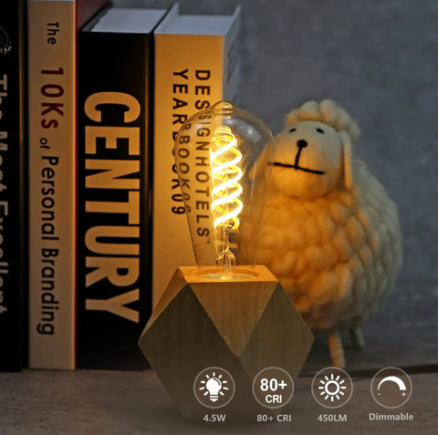 Vintage style LED filament bulb on wooden base next to books and a sheep figure, Six Pack G25 LED Globe Edison Bulbs Dimmable Filament Style E26 Base 6W Equal 60W Neutral White 4000K Glass Edison Look For Bathroom Vanity Mirror Lighting Dope Glow.