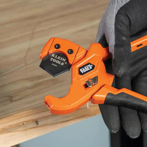 Lightweight PEX Pipe And Tubing Cutter With Soft Molded Handles And Pierce Point Blade for clean PEX cuts, orange tool in hand