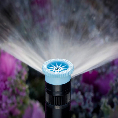 Adjustable Arc Sprinkler Nozzle For Lawns, 6-Foot Radius, 0-360 Degree Spray Pattern, installed among flowers