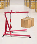 Tough as Nails Hydraulic Engine Hoist 1 Ton Cherry Picker Shop Crane with Smooth Rolling Wheels lifting a box.