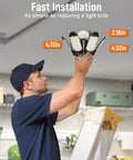 Man installing Ultra Bright Four Pack 40000 Lumen LED Garage Light With 6 Plus 1 Deformable Panels Screws Into E26 E27 Bases
