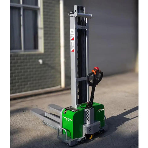 All Electric Dump Forklift Pallet Stacker With Portable Lifting Truck And Fixed Cross Leg Design Built Tough For The Daily Grind While Smashing Through Heavy Loads With Zero Sweat Featuring A Massive 2204 Pound Capacity And Six Foot Lift. Green electric pallet stacker with gray mast and compact base.