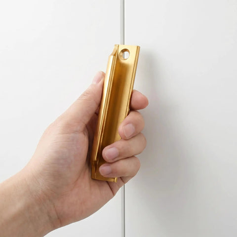 Hand holding Two Piece Aluminum Alloy Drawer Pull Handles 3.5 Inch Low Profile Sash Lift Finger Pulls For Kitchen Cabinets And Dressers, Rust Proof Gold Finish