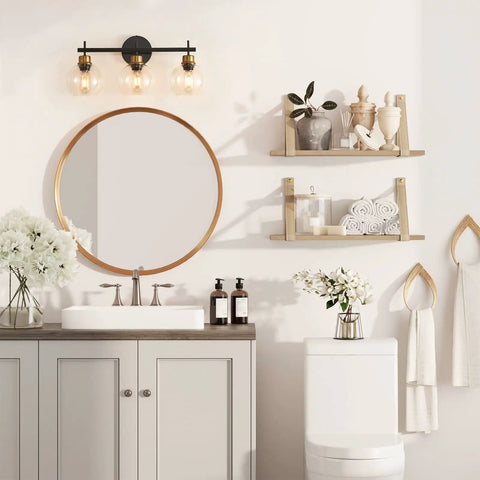 Three Light Black And Gold Bathroom Vanity Light Fixture With Metal Base And Clear Glass Globe Shades above mirror in bathroom