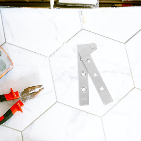 Four Pack Stainless Steel Pivot Hinges With Thickened Design And Rotating Shaft for doors and windows on a tile surface.