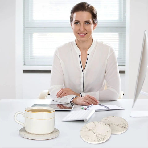 Smiling woman at desk with 6 Pack White Marble Coaster Set With Holder, Absorbent Ceramic Drink Coasters For Bar And Coffee Table, Cute Modern Cork Non Slip Desk Decor, Totally Cool Gift Idea For Home Or Office, Stone Style Coasters