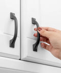 Hand using one of the 20 Pack 3 Inch Matte Black Kitchen Cabinet Pulls No Fuss Easy Install Solid Metal Handles For Cabinets Drawers Cupboards Kitchens Bedroom Dresser And Home Renovation Hardware Built To Last on white cabinet