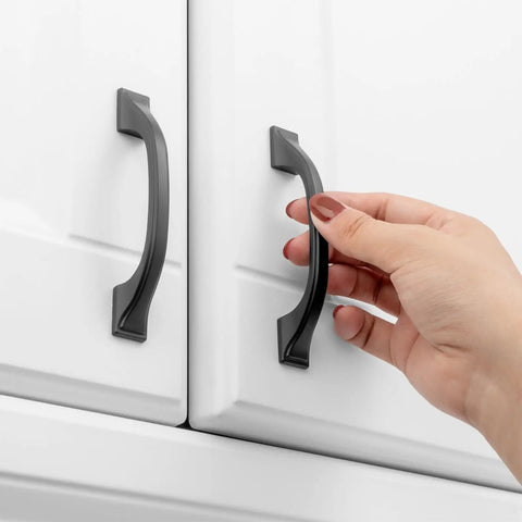 Hand using one of the 20 Pack 3 Inch Matte Black Kitchen Cabinet Pulls No Fuss Easy Install Solid Metal Handles For Cabinets Drawers Cupboards Kitchens Bedroom Dresser And Home Renovation Hardware Built To Last on white cabinet