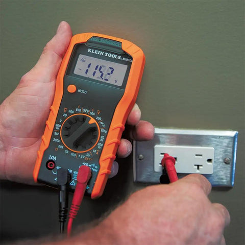 Digital Multimeter With Manual Ranging For Everyday Electrical Troubleshooting measures voltage on wall outlet.