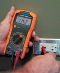 Go To All In One Electrical Tester Kit With Digital Multimeter, person using DMM on wall outlet in close-up view