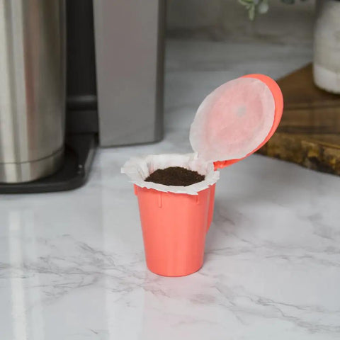 EZ Carafe Disposable Paper Filters with Patented Top Lid on Keurig K Carafe Reusable Coffee Pod, filter filled with coffee grounds.