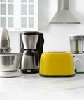 Kitchen countertop with a mixer, coffee maker, toaster, and blender in a modern kitchen setting.