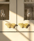Heavy Duty Butterfly Cabinet Knobs With Slick Brushed Gold Finish For Dressers Crafted From Legit Solid Brass Featuring Smooth Wings on cabinets