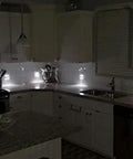 Two Pack Wall Plate Night Lights LED Built Into Outlet Plates Duplex White in dark kitchen, auto on for safety.