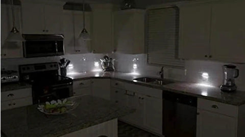 Two Pack Wall Plate Night Lights LED Built Into Outlet Plates Duplex White in dark kitchen, auto on for safety.