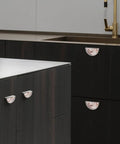 Rose Gold Blush Fluid Cabinet Pulls 2 Pack 3 Inch Center Hole Semi Circle Drawer Handles with marble pattern installed on dark cabinets
