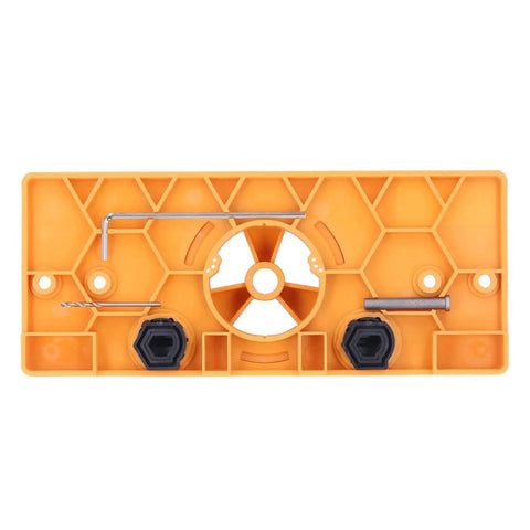 Get Ready For Serious Woodworking With This Ultimate Hinge Hole Saw Jig Set, showing the orange jig with hexagonal pattern and accessories.
