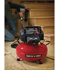 Workhorse Pancake Air Compressor With Six Gallon Oil Free Tank 150 PSI Max Pressure in garage with nail gun usage.
