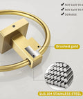 Close-up of gold toilet paper holder showing brushed brass finish and SUS304 stainless steel construction, wall mounted.