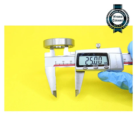 6905 Hybrid Ceramic Bearing 25X42X9MM ABEC-1 Si3N4 Steel Rings measured at 25mm using calipers on yellow background
