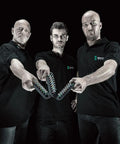Three men holding Zyklop One Quarter Inch Socket Belt Sets with holding function in black shirts against a dark background.