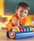 Child in classroom using Six Jumbo Science Magnifiers With Stand For Kids Ages 3 Plus, durable plastic lenses, easy grip design.