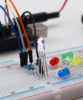 Close-up of All In One Tinker Ready Starter Electronics Kit with power supply, breadboard, LEDs, resistors, and jumpers.