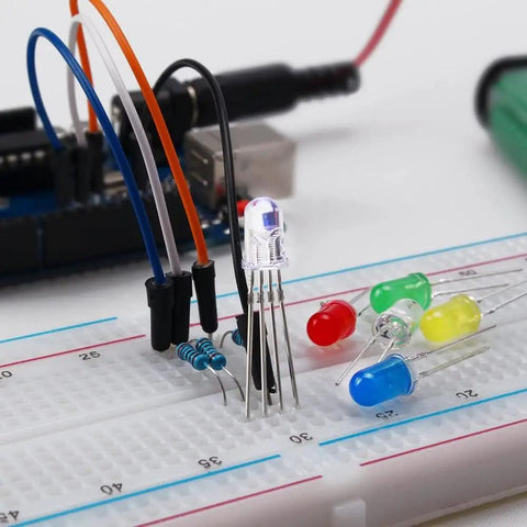 Close-up of All In One Tinker Ready Starter Electronics Kit with power supply, breadboard, LEDs, resistors, and jumpers.