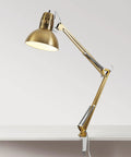 Gold swing arm desk lamp with clamp-on base, adjustable arm, and rotary switch on white background. Product is not white with nickel accents.