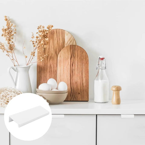 White Mini Finger Edge Pulls 8 Pack Concealed Drawer Handles displayed on kitchen cabinet with decor