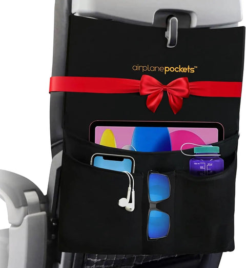 Air Travel Tray Cover And Seat Back Organizer for Flights with gadgets and snacks in black expandable pockets.