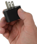 Hand holding 15A To TT-30R RV Plug Adapter NEMA 5-15P To TT-30R 125V 30A Power Converter, black.