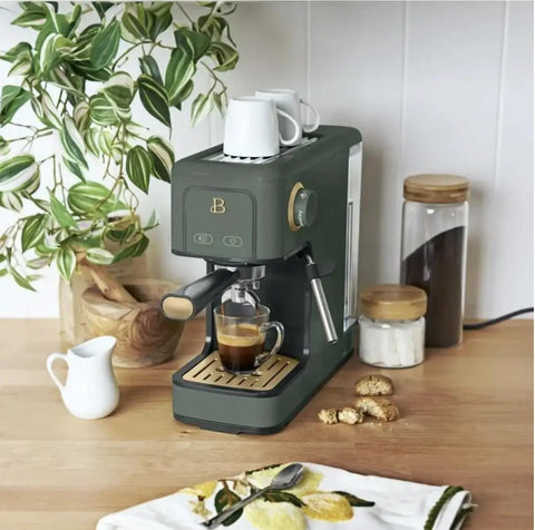Rock Solid Compact Espresso Machine In Fresh Thyme Green with 20 bar pump brewing coffee on kitchen countertop.