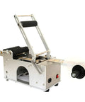 Heavy Duty Semi Auto Round Bottle Labeler For 15 To 120 Mm Containers Runs Like Clockwork At Forty Labels Per Minute, side view of machine.