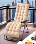 Plush beige reclining lounger on a balcony with city view, featuring comfortable padded cushion for relaxation.