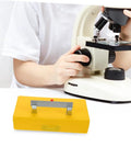 Child using Reliable Conductivity Learning Kit next to microscope, part of Multi Functional Science Lab Tool for Hands On Physics Experiments.
