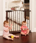 Stone Arch Auto Close Baby Gate For Doorways Bronze Metal Safety Gate Sturdy Adjustable shown in kitchen doorway with two children