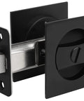 Close-up of Dope Matte Black Square Pocket Door Lock Kit With Hardware For 2-1/8 Inch Bore showing latch and lock mechanism.